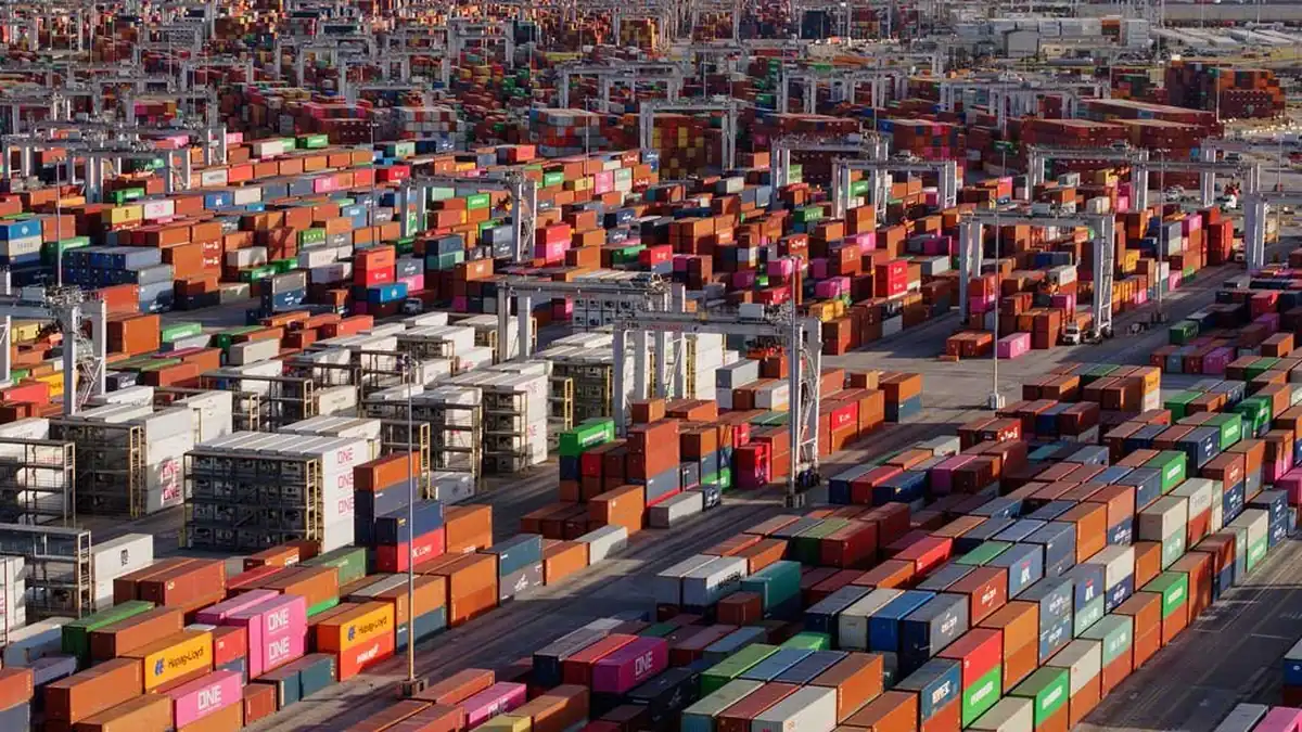 Container yard seen from above, rows of stacked containers running to the horizon.