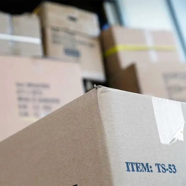 Close-up of taped and labelled export cartons stacked for packing.